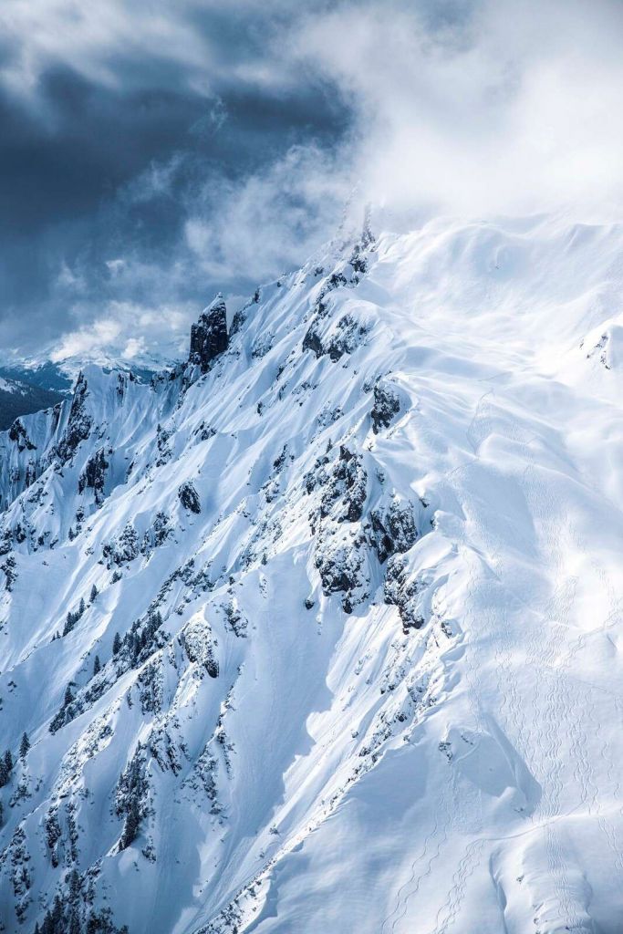 Sneeuwkammen onder stormachtige wolken