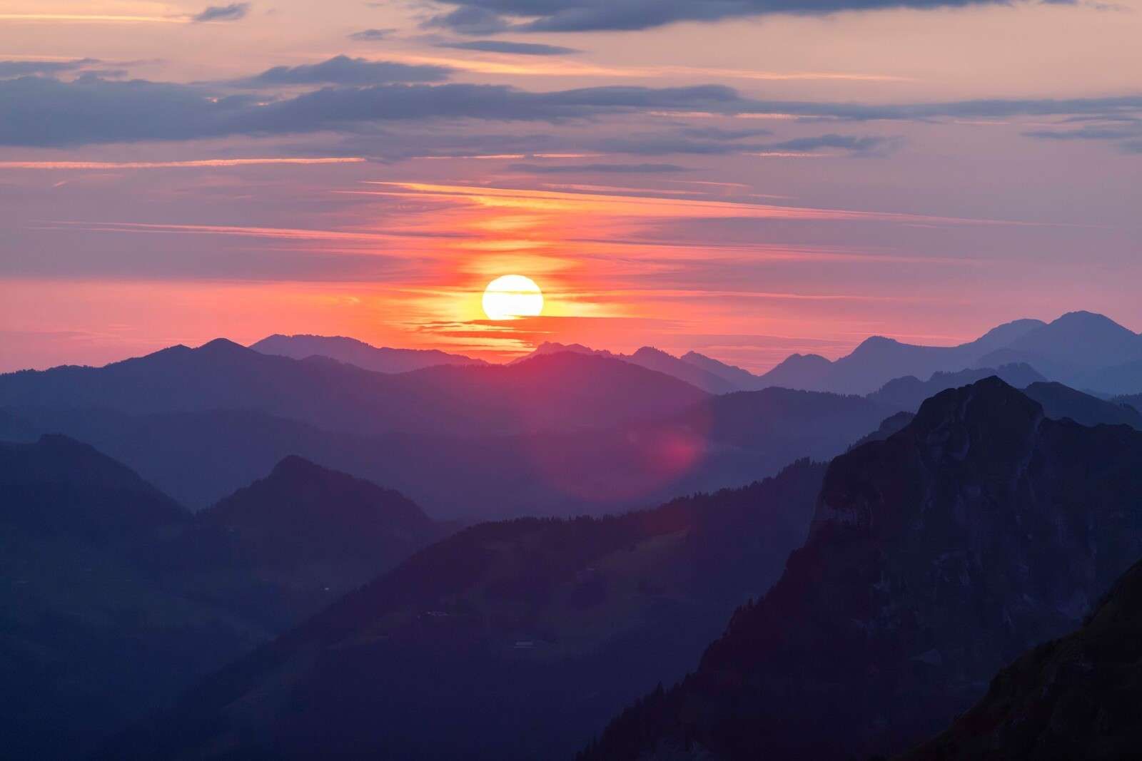Zonsondergang boven paarse berglagen